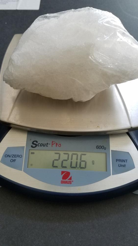 Drugs seized on a scale weighing 220.6 grams.