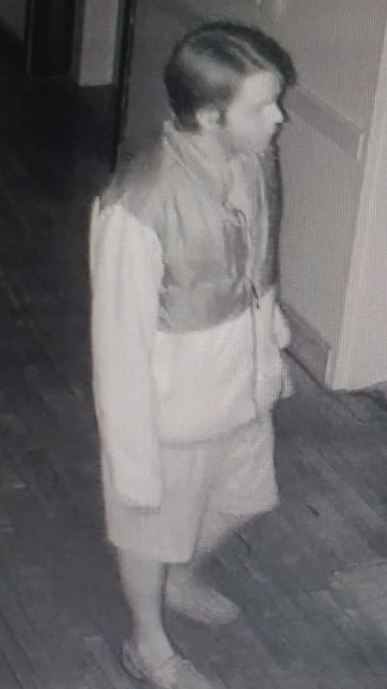 One of the suspects looking away from the security camera.