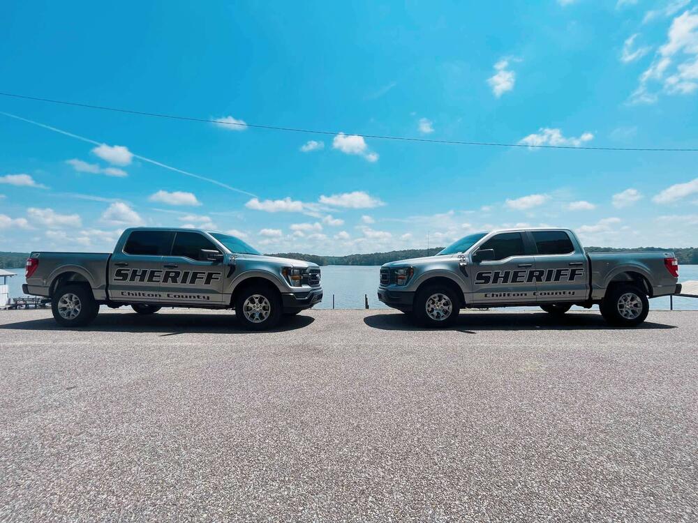 Two Chilton County patrol trucks facing each other